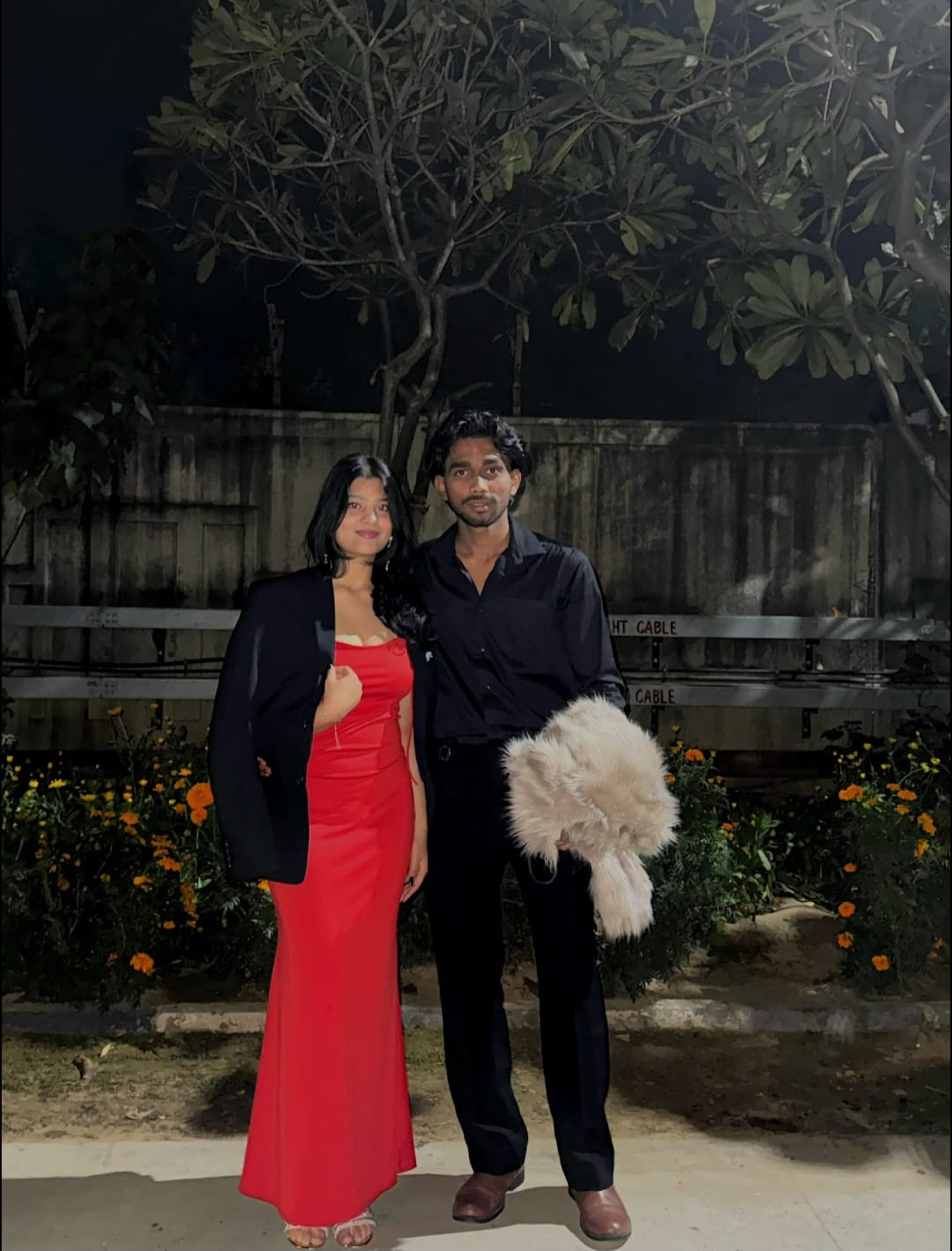 Red dress. Black suit. Main character energy.